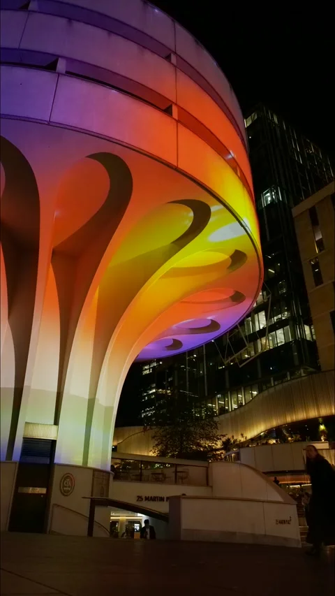 Vertical time lapse Sydney people pass VIVID light show on modern building Stock Footage 310496889
