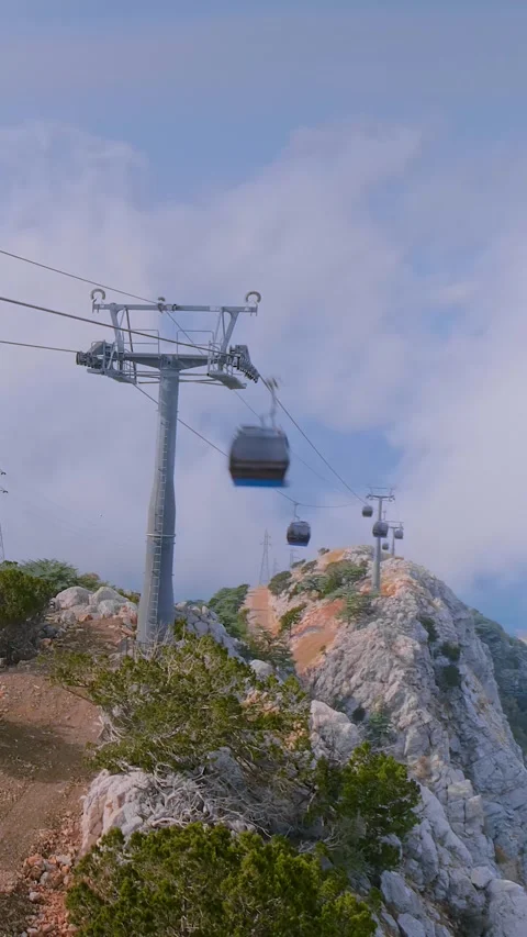 Vertical, timelapse: cable car cabins and clouds are moving fast Stock Footage 341854998