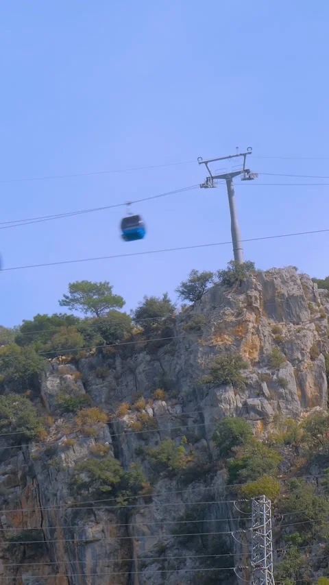 Vertical, timelapse: cable car cabins moving over rugged mountain terrain Stock-Footage 344966521