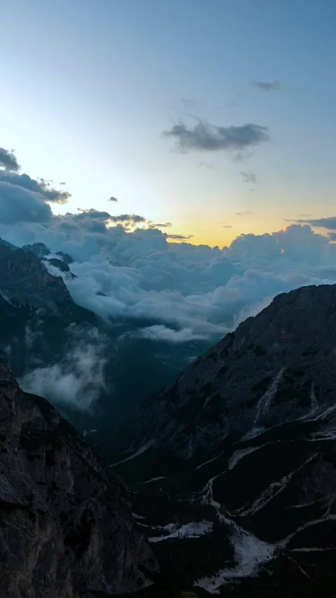 Vertical Timelapse of Clouds Moving Above Valley in Ampezzo Dolomites at Stock Footage 341652027