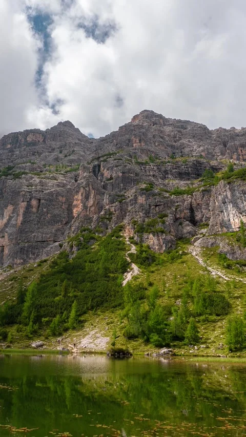 Vertical Timelapse of Clouds Moving Above Italian Dolomites and Federa Lake in Stock Footage 341652172