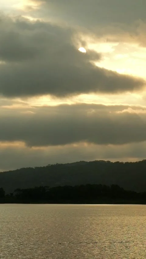 Vertical timelapse of dark clouds at sunset at the lake Stock Footage 320029375
