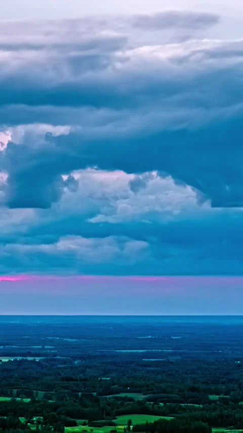 Vertical Timelapse of Dramatic Clouds Moving Over Rural Landscape at Dusk Stock Footage 340903742