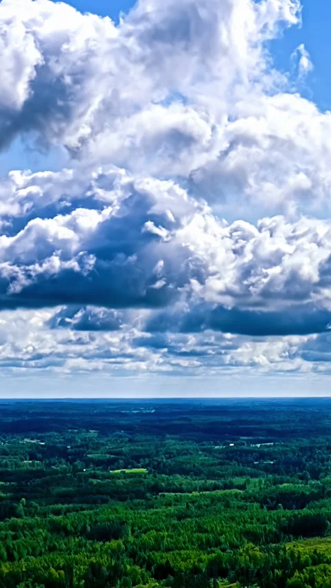 Vertical timelapse of dramatic cumulus clouds and rolling shadows over endless Video stock 345130831