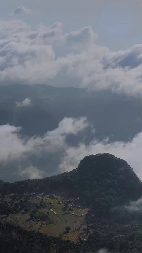 Vertical, timelapse: drifting clouds and occasional paraglider at Babadag Video stock 341855117
