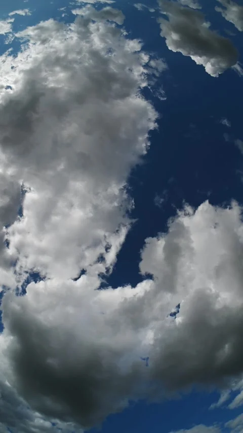 Vertical timelapse of a fisheye view of white summer clouds moving through a Stock Footage 341835242