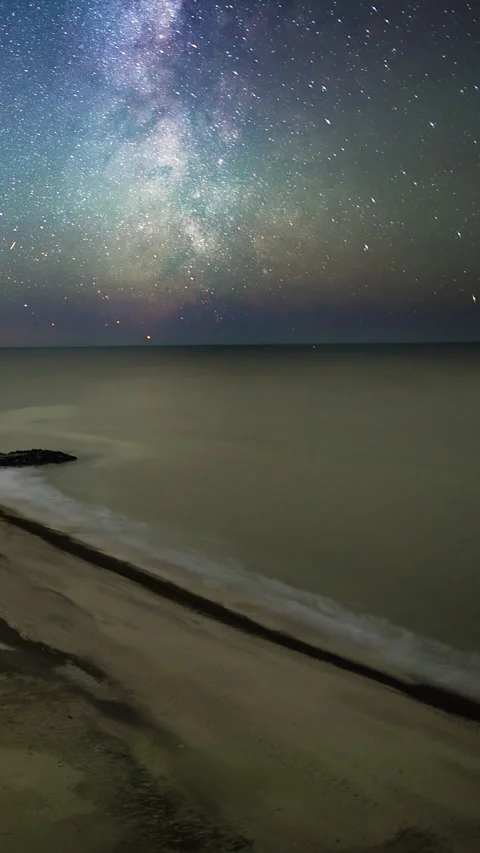 Vertical Timelapse milky way starry night sky over beach and sea Stock Footage 280177627