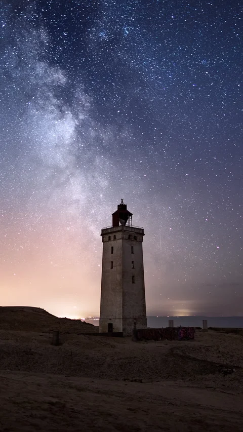 Vertical Timelapse Night sky over tall lighthouse milky way and moonlight Stock Footage 280179670