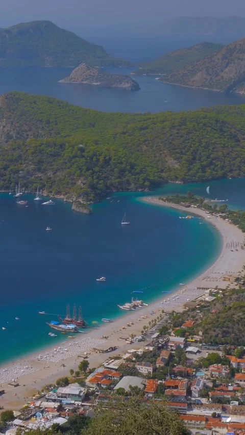 Vertical, timelapse: paragliders gliding fast and boats sailing - Blue Lagoon Stock Footage 339029920