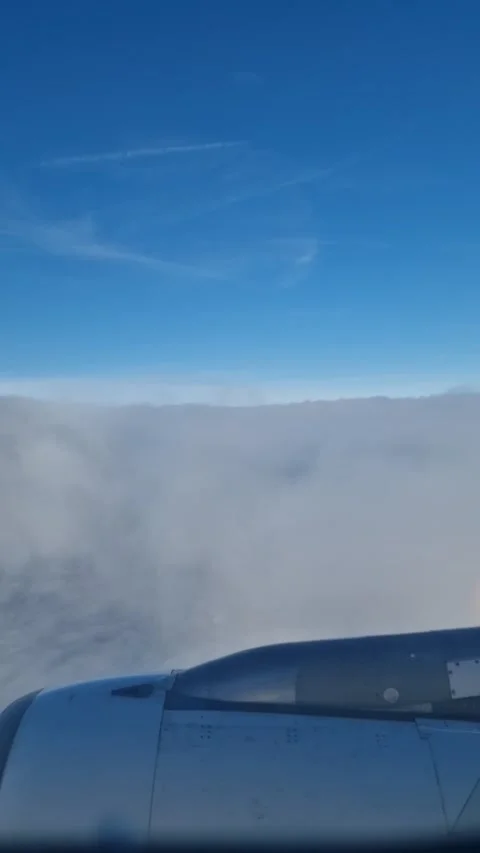 Vertical timelapse of plane going through the clouds on its descent Stock Footage 233532206