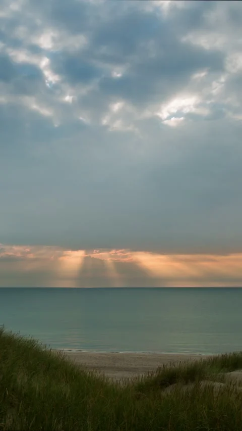 Vertical Timelapse Rays of Light moves calmly across horizon at sea and beach Stock Footage 280177158