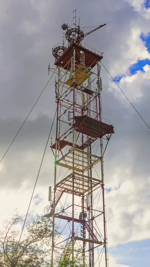 Vertical Timelapse of Red Industrial Communication Tower Against Cloudy Sky Stock Footage 337689233