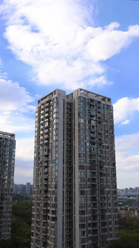 Vertical time‑lapse of residential apartment tower with drifting clouds Stock Footage 344829822