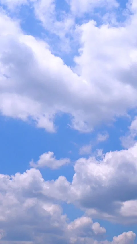 Vertical, timelapse shot of movement of clouds in blue sky. Summer sky. 4K Stock Footage 346801553
