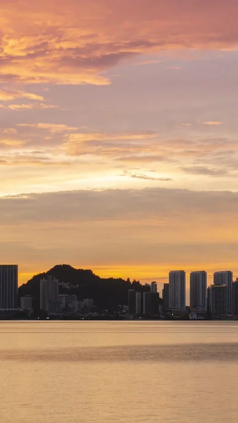 Vertical timelapse silhouette view of waterfront city with highrise skyscra.. Video stock 229751262