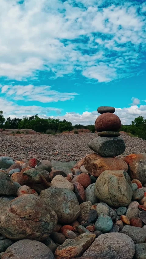 Vertical timelapse of stacked rocks against a moving sky Stock Footage 337137940