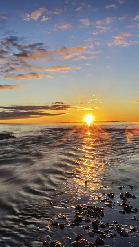 Vertical timelapse sun setting where river runs into sea in beautiful evenin Stock Footage 280179219