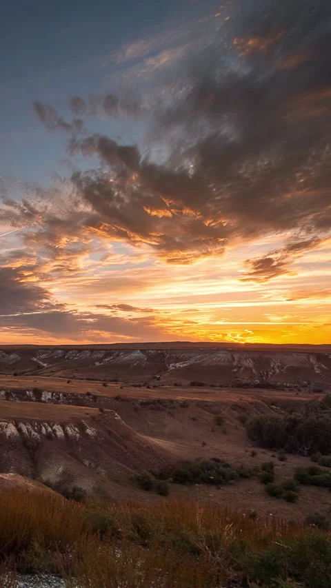 Vertical timelapse sunset over chalk hills with dramatic clouds and glowing sky Stock Footage 330604674
