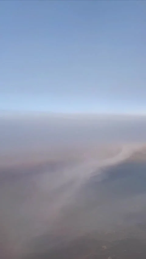 Vertical timelapse view from an aircraft window above clouds during sunrise or s Stock Footage 331888153