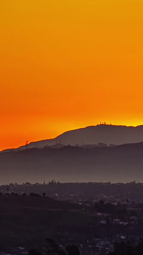 Vertical timelapse view of a silhouette hill during sunset. Stock Footage 317626136