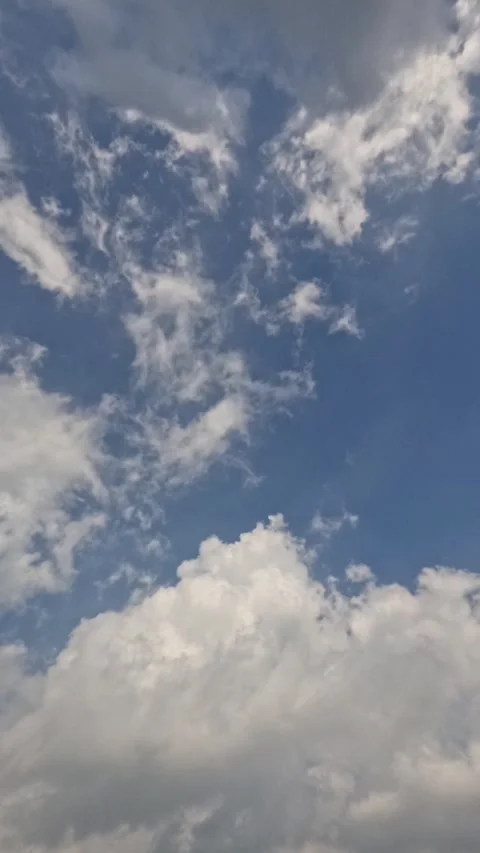 Vertical timelapse of white and gray clouds rolling in the blue sky. Stock Footage 320941470
