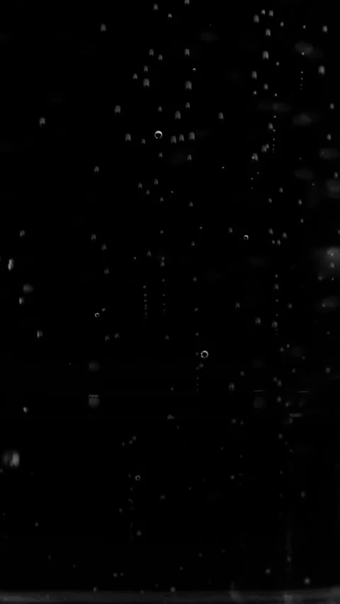 Vertical tiny small air bubbles continuously rising on pure black background. Stock Footage 337406792
