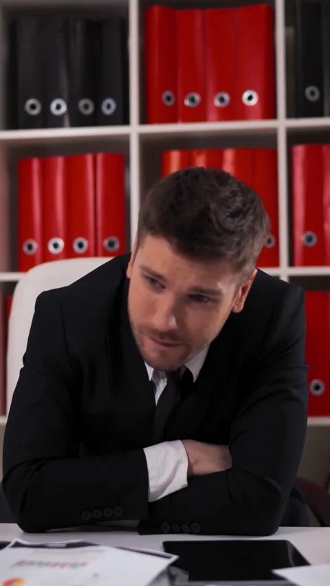 Vertical of Tired businessman with documents falling asleep in office Video stock 305498797