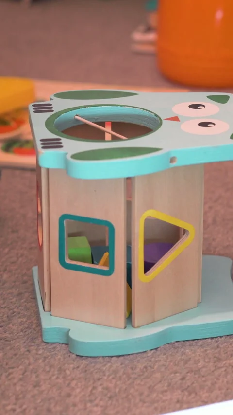 Vertical Toddler Dropping Blocks Successively Into Shape Sorter Stock Footage 329368540
