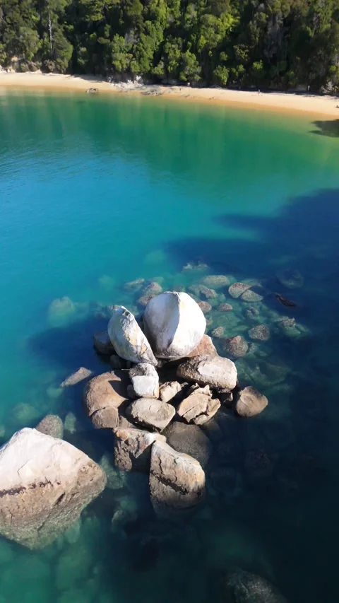 Vertical Top Down Aerial of Boulder in Turquoise Water Stock-Footage 334000422