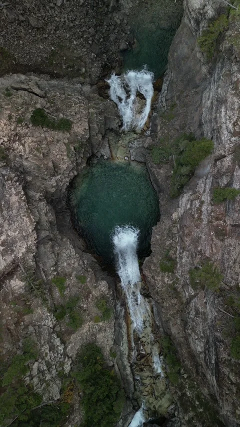 Vertical top down aerial of Devils Punchbowl waterfall in Crested Butte Colorado Stock Footage 256043625