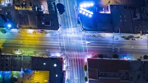 Vertical top down aerial view of traffic on street intersection at night Stock Footage 71223796