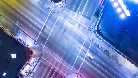 Vertical top down aerial view of traffic on street intersection at night. Video stock 71223917