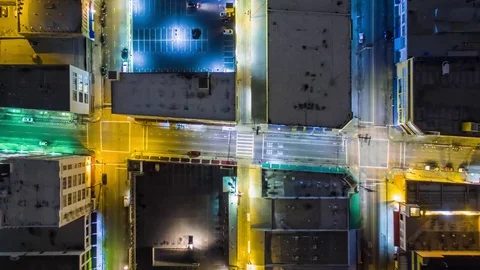Vertical top down aerial view of traffic on streets and intersections at night Stock Footage 71243273
