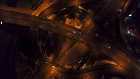 Vertical top down aerial view of traffic on freeway interchange at night, fast Stock Footage 88411020