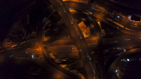 Vertical top down aerial view of traffic on freeway interchange at night. Video Stock Footage 89068248