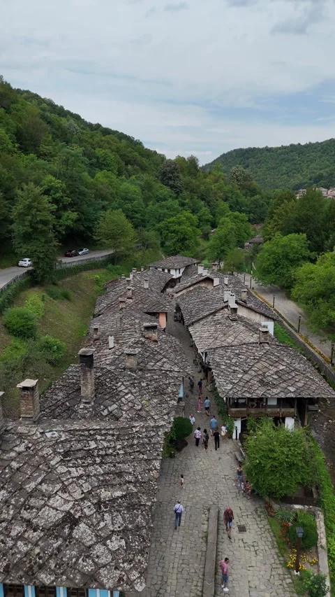 Vertical top-down aerial view of stone roofs in a traditional Balkan village. Stock Footage 327670279