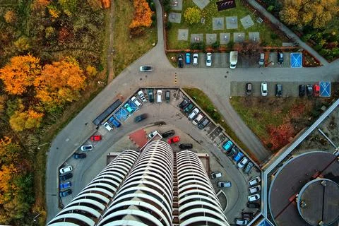 Vertical top-down aerial view of a Kukurydze skyscraper roof, parking lot, an Stock Photos