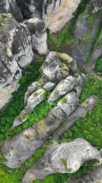 Vertical Top Down Aerial View of Majestic Rock Cliffs and Forest Stock Photos