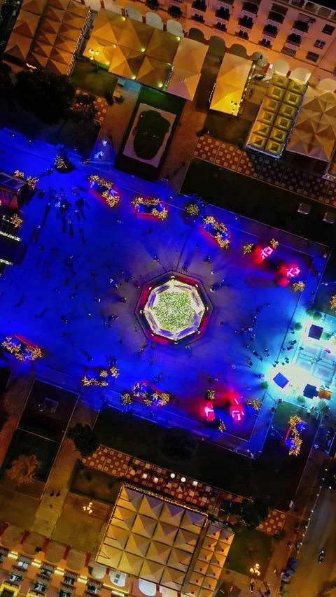 Vertical top-down drone rotating over illuminated Christmas square Stock-Footage 345934191