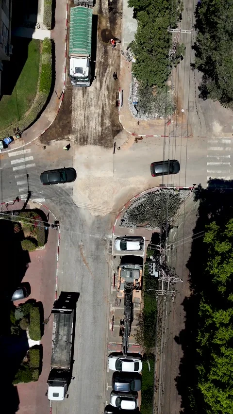 Vertical top-down drone tracking shot of asphalt delivery truck laying fresh Stock Footage 338424389