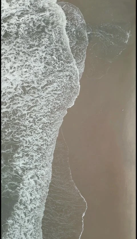 Vertical Top Down Drone View of Ocean Waves Rolling onto Sandy Beach. Stock Footage 330361453
