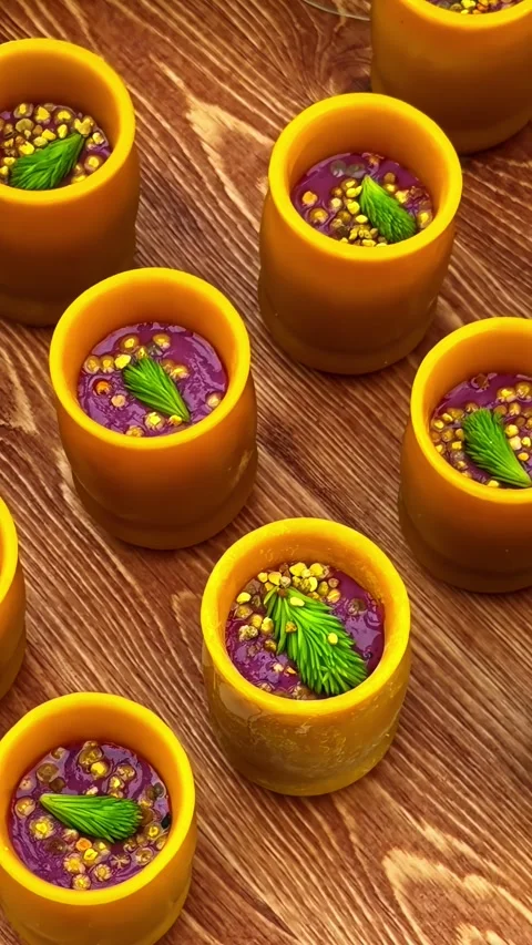 Vertical top down panning shot of gourmet appetizers in edible beeswax cups Stock Footage 344526318