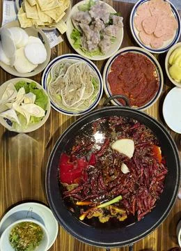 Vertical Top Down Shot of Boiling Spicy Hot Pot Broth and Meat Stock Photos