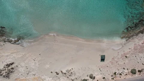 Vertical top down shot of exotic beach with camping tent and turquoise sea Stock Footage 337046293