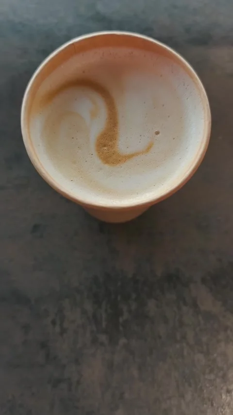 Vertical Top-Down View of Coffee with Latte Art in a Paper Cup Stock Footage 316685417