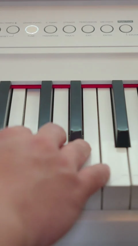Vertical top down view of hand playing white digital piano keys close up Video stock 337929806