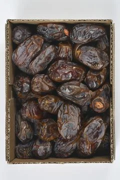 Vertical top down view of packed Medjool dates in a cardboard box Stock Photos
