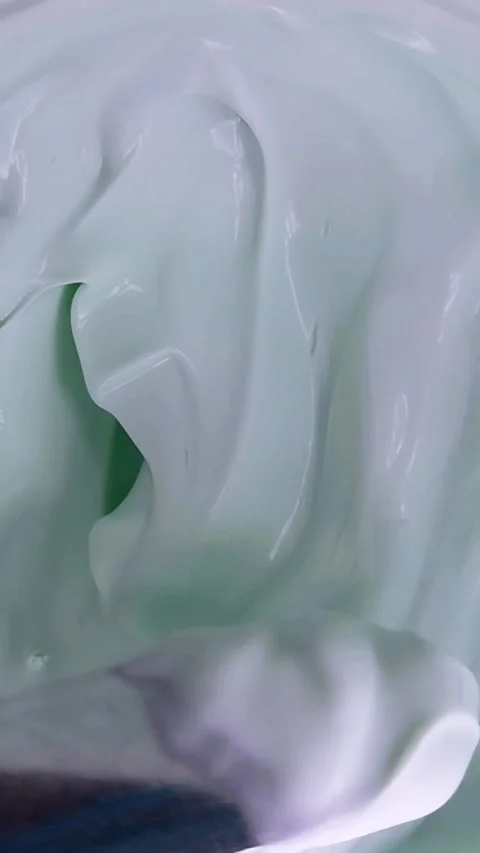 Vertical top down view of stirring cream in a circular motion using a metal.. Stock Footage 339305199