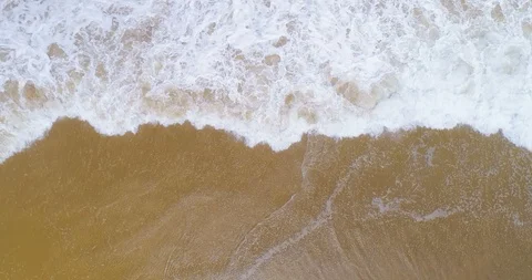 Vertical top down view of waves breaking on golden beach good vertical wipe a Vídeo Stock 87573245