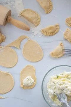 Vertical top view of circle cut dough in a process of making pierogi Fotos Stock